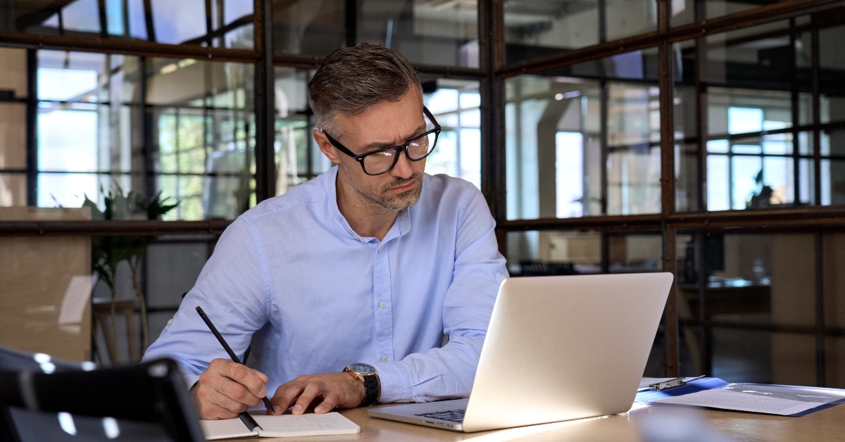 businessman having virtual meeting video conference taking notes