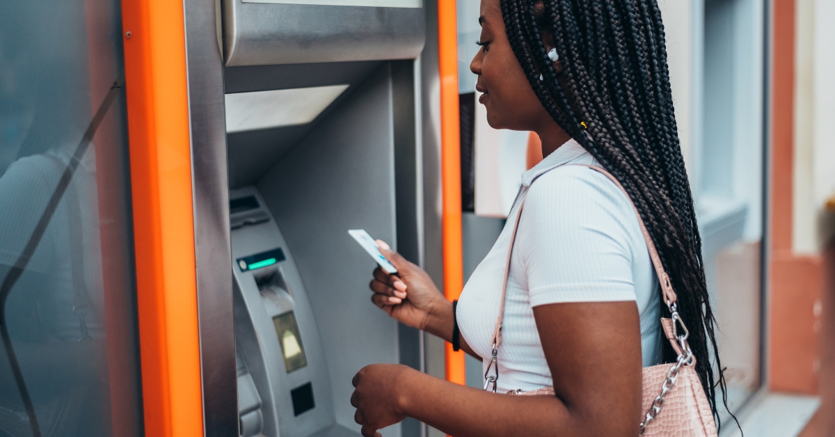 woman using atm machine and a credit card