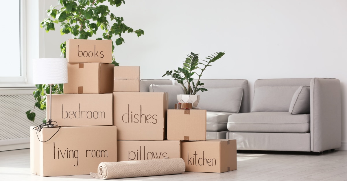 lounge full of moving boxes with labels in front of couch
