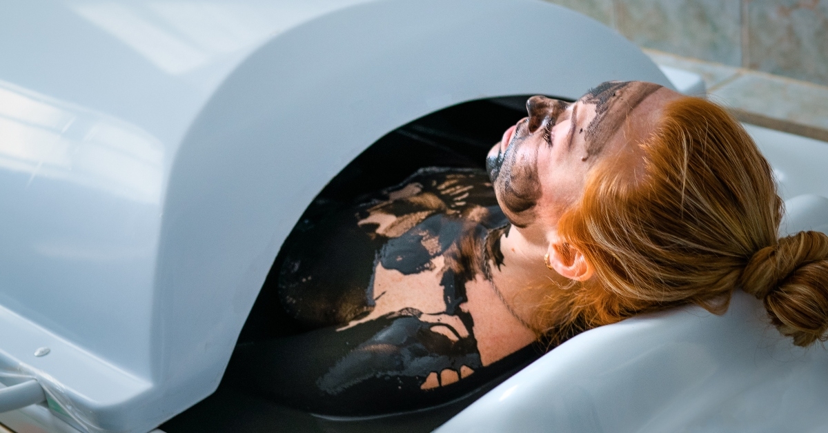 woman enjoying mud bath alternative therapy