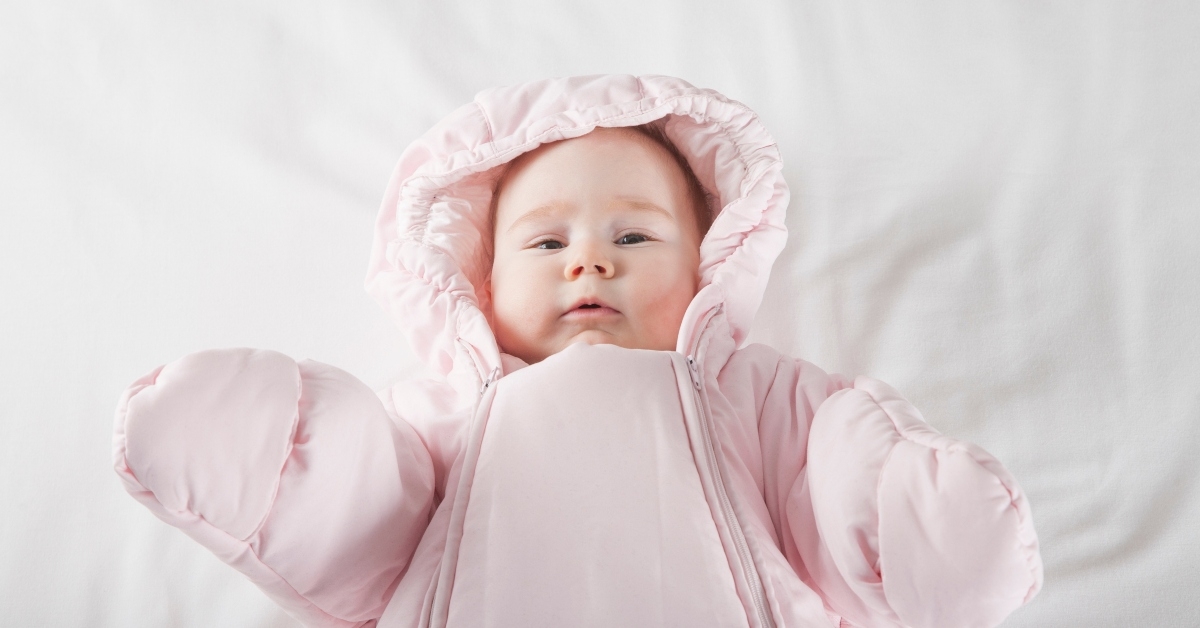 baby face wrapped in pink snowsuit
