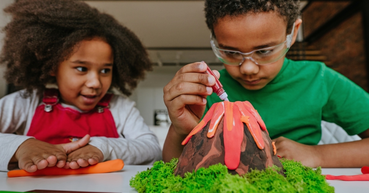 children making DIY volcano model from kids play clay