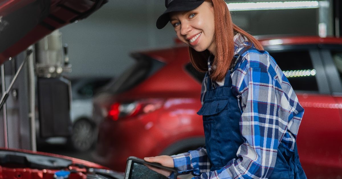 beautiful female mechanic fixing a car