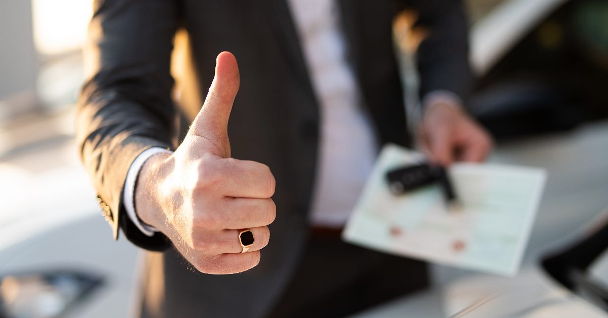 man in suit giving thumbs up