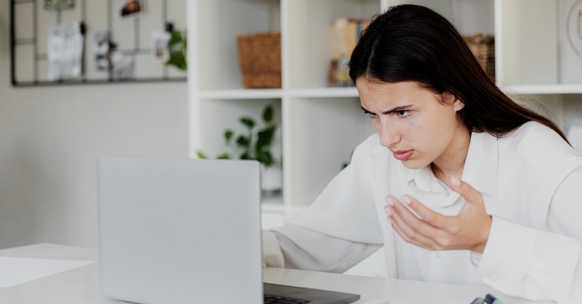 unhappy confused female distressed with laptop troubles