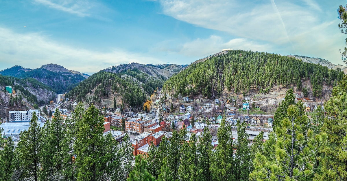 aerial shot of deadwood in south dakota with buildings and trees