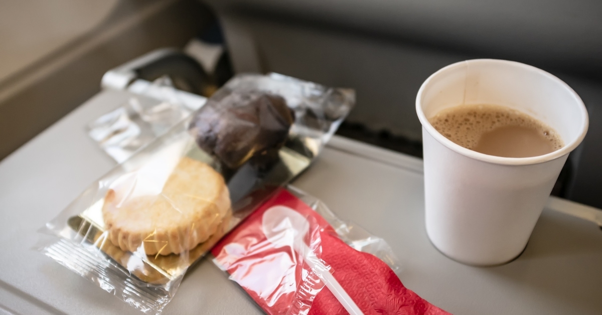 small snack in an airplane on rear seat table