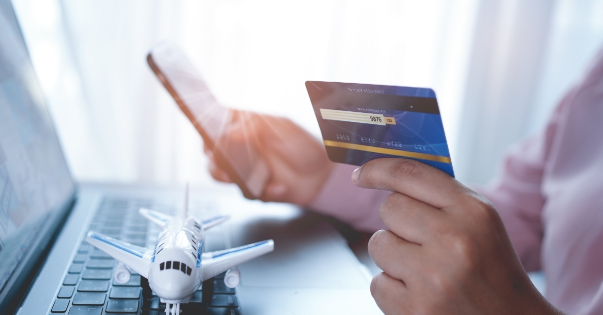 tourist is booking plane tickets online using a credit card