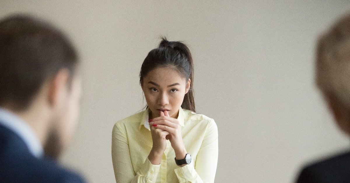 asian woman stressing out sitting in front of hr managers