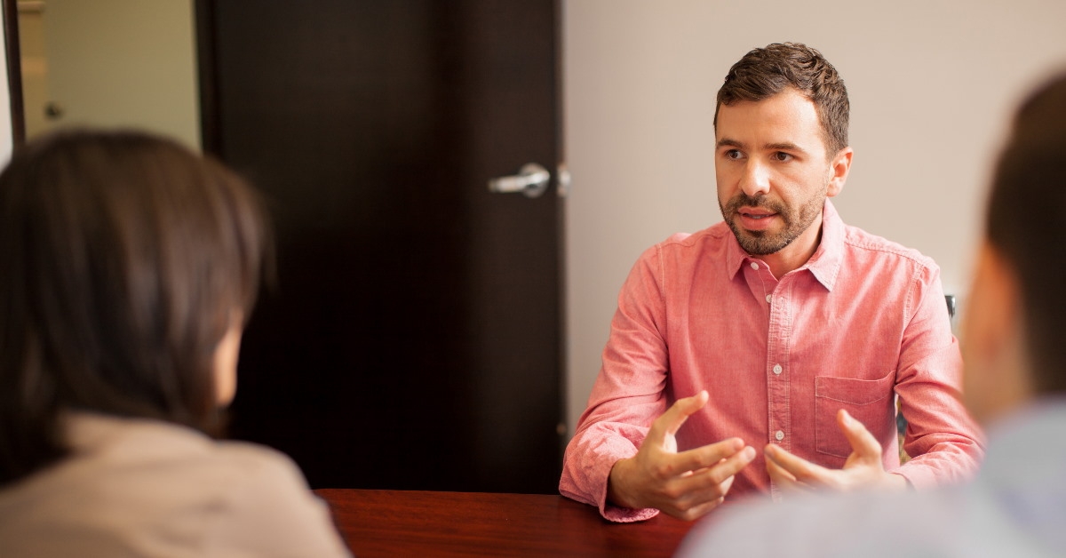 young man talking to higher authority in office interview