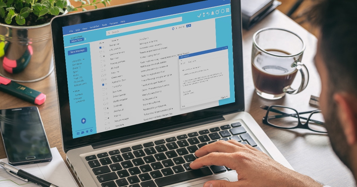 businessman writing email on laptop 