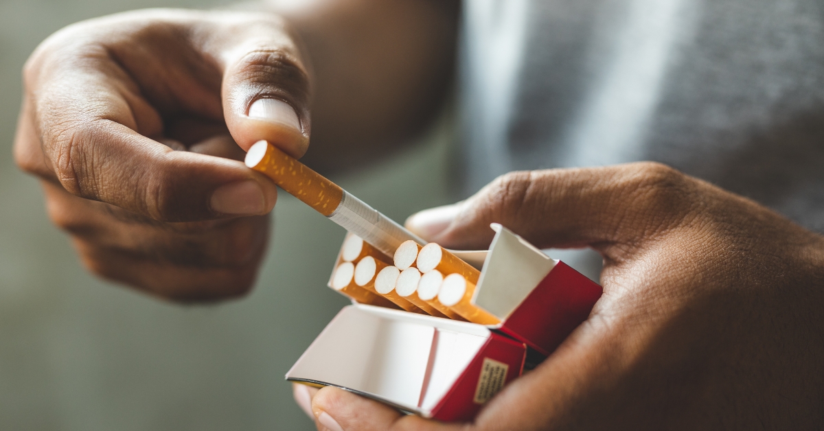 male hand holding a cigarette