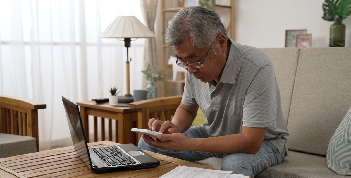 man counting on calculator