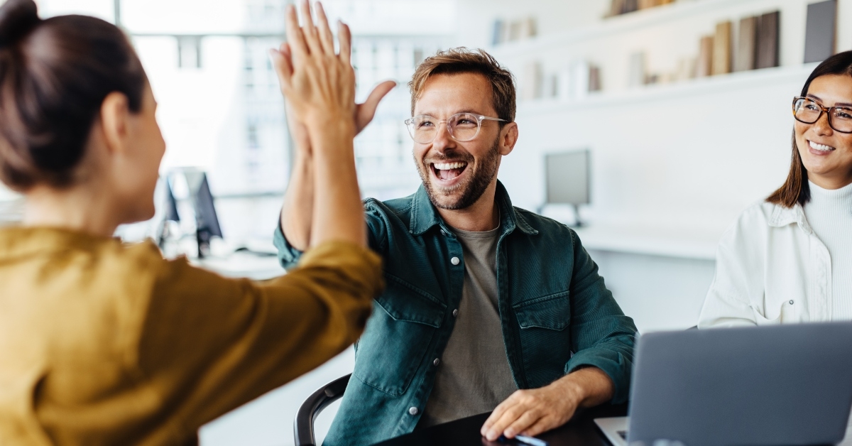 business people celebrating success in an office