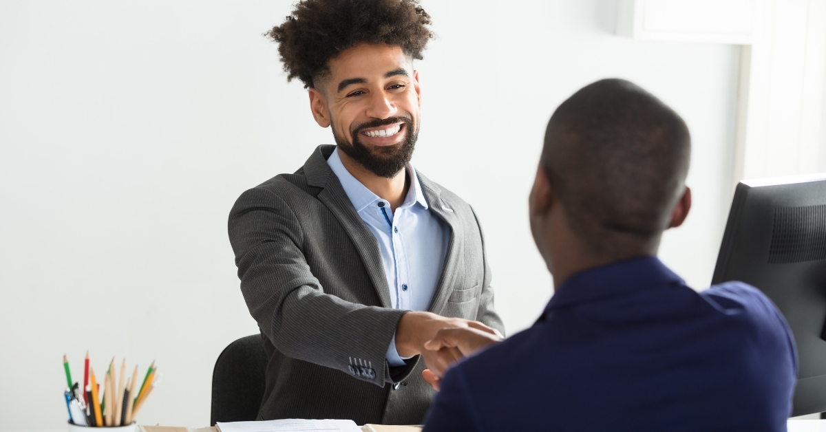 businessman shaking hand with male candidate