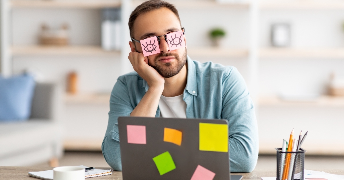 man having stickers with open eyes drawing on glasses