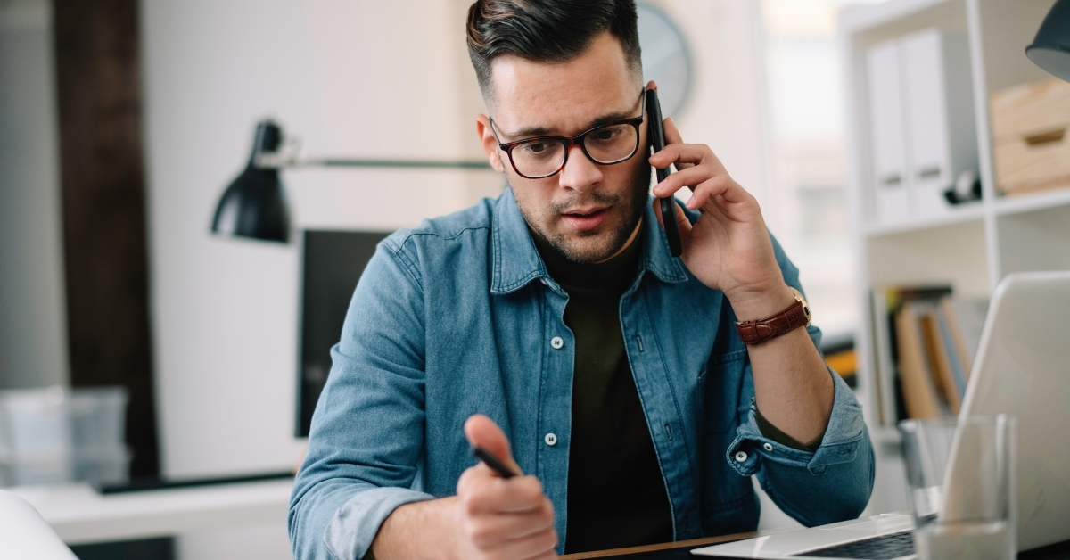 man talking on phone at work