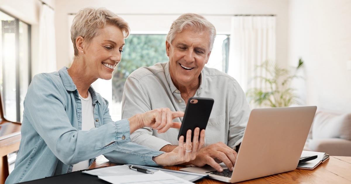 phone laptop and finance with a senior couple
