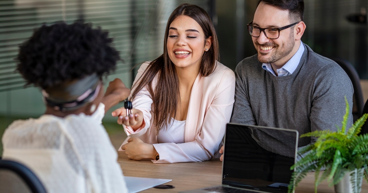 real estate agent handing the keys to customers
