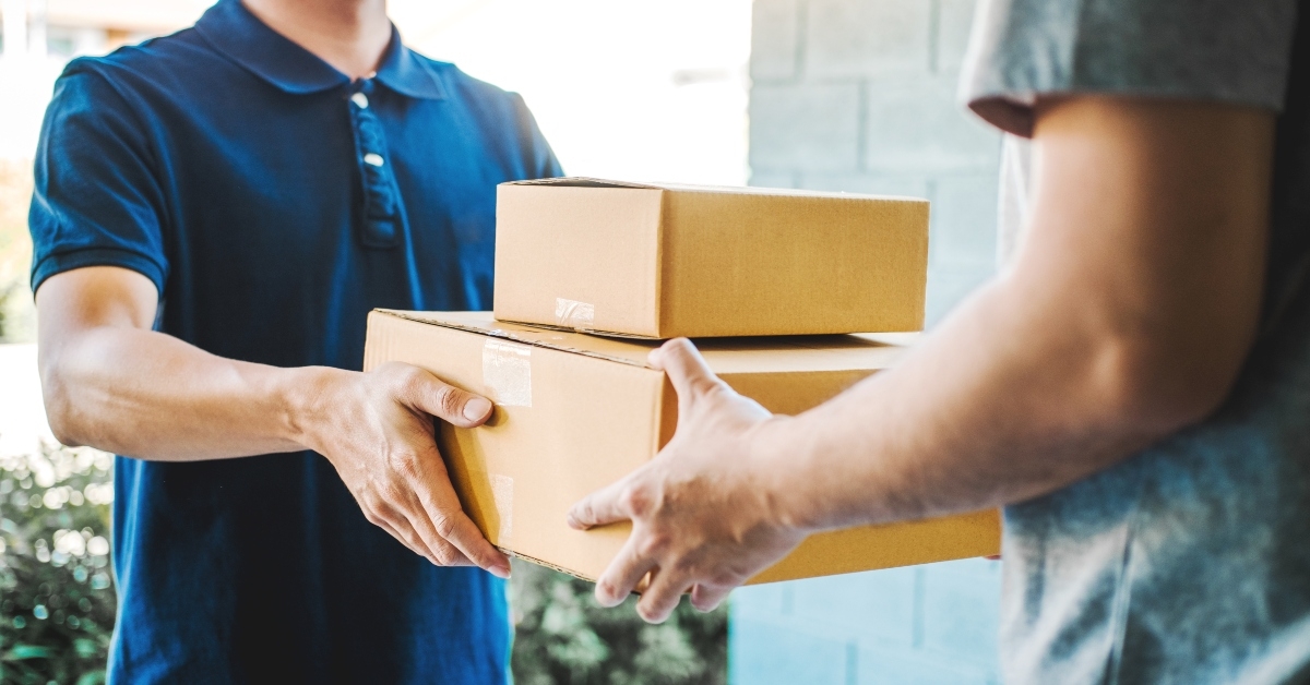 man accepting delivery boxes