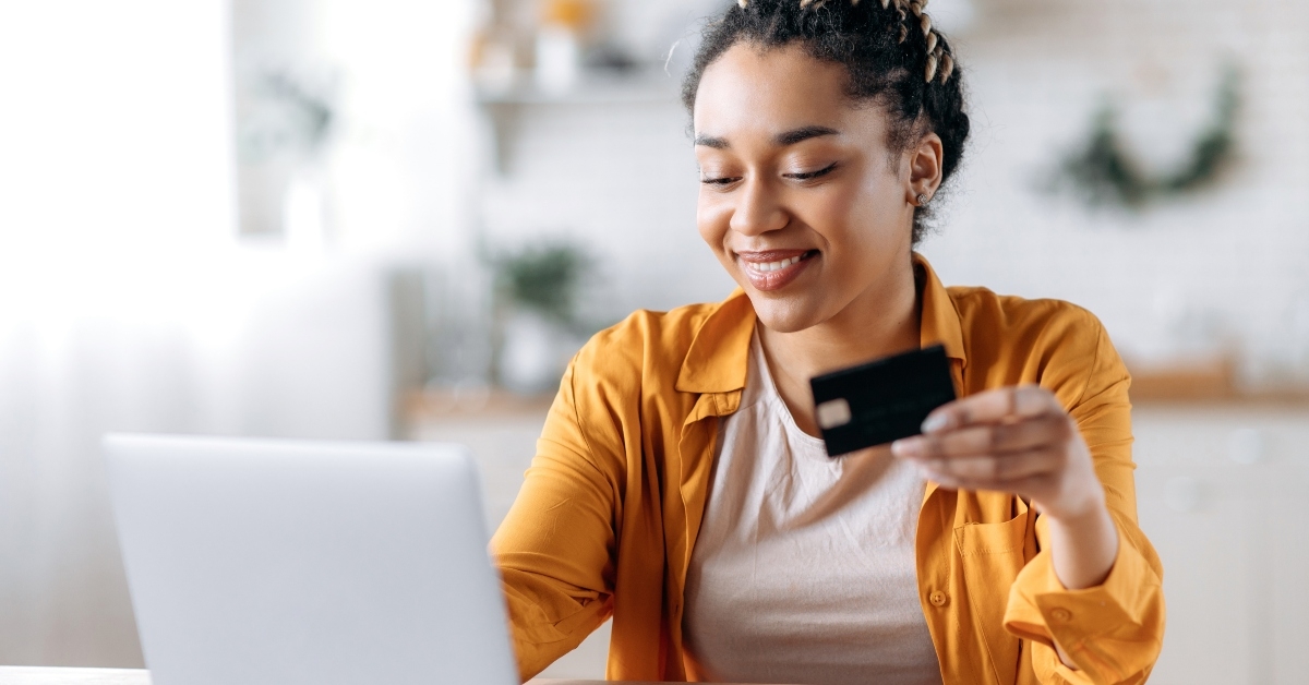 woman stylishly dressed paying for online purchases
