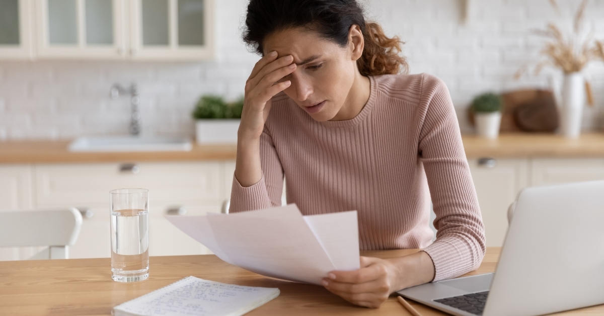 stressed millennial female freelancer scratching forehead