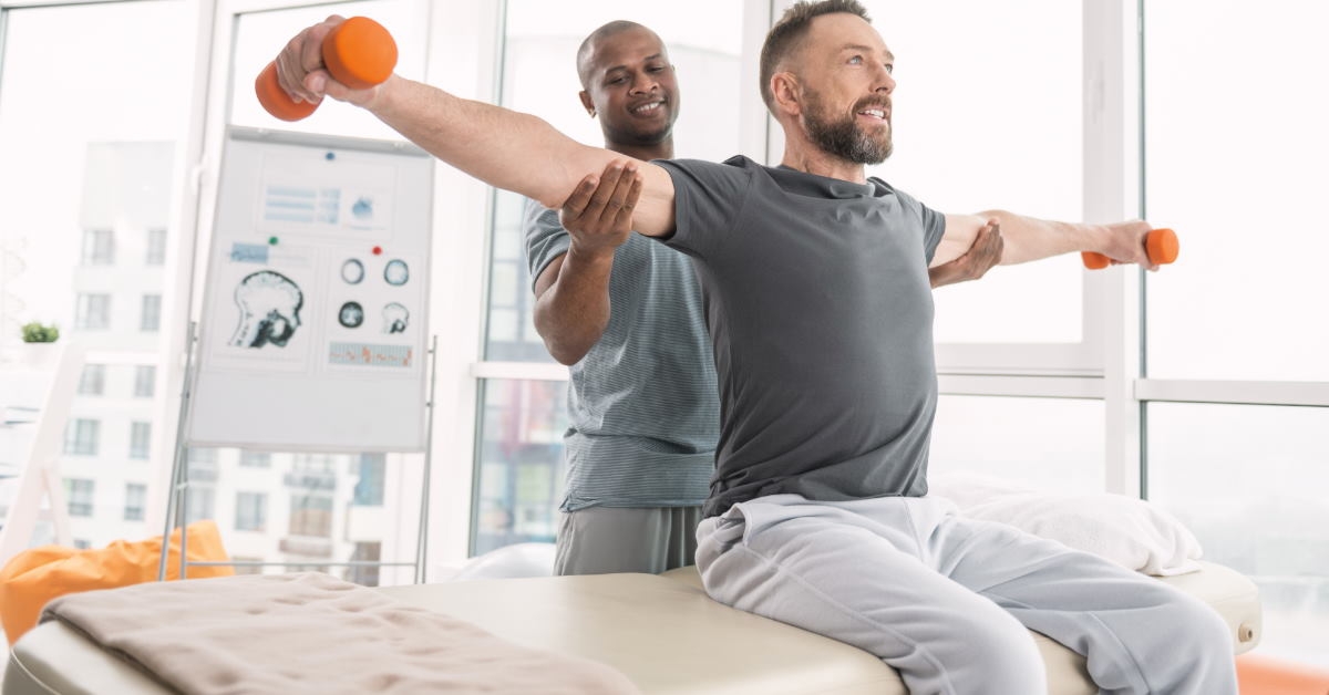 african american physiotherapist guiding young man to workout while holding his shoulders