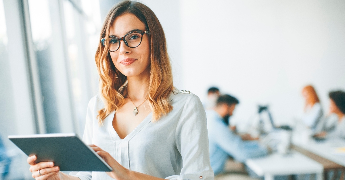 beautiful businesswoman in glasses using a tablet in her office 