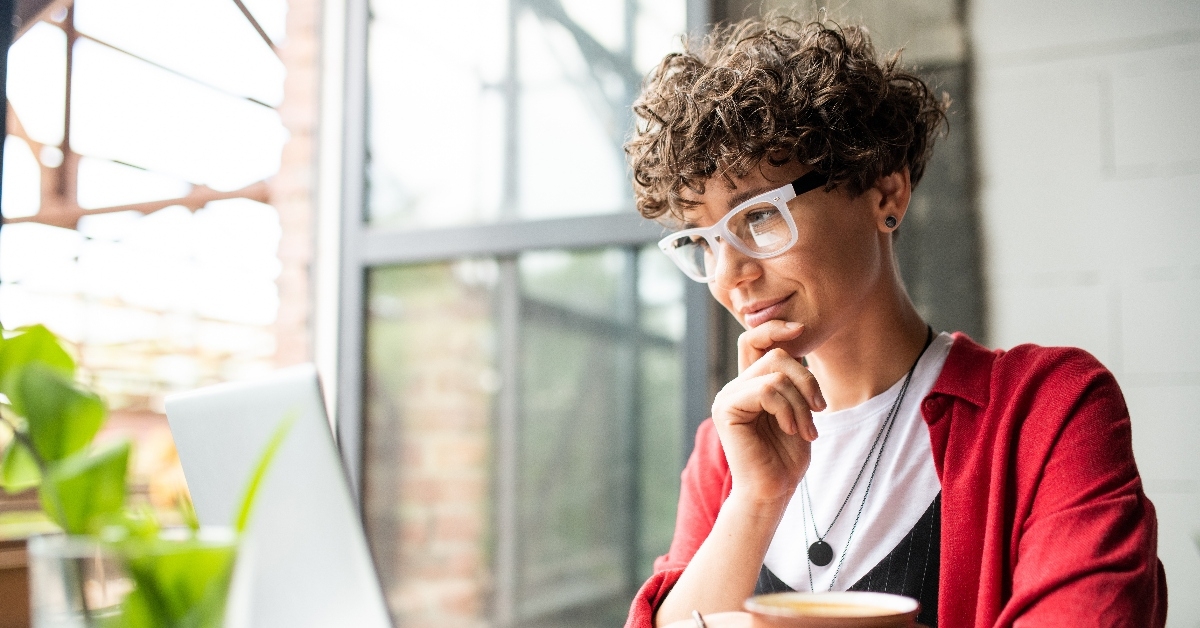 woman with glasses using laptop 