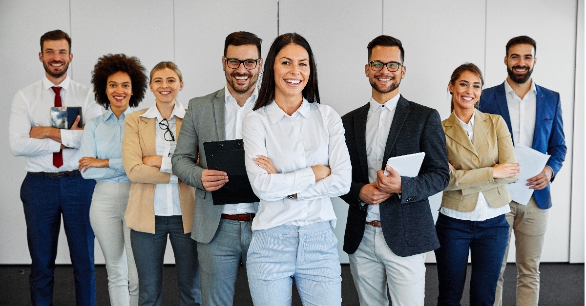 business team holding documents along with their colleagues