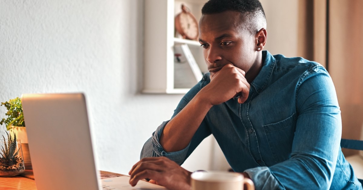 african american man working from home using laptop 
