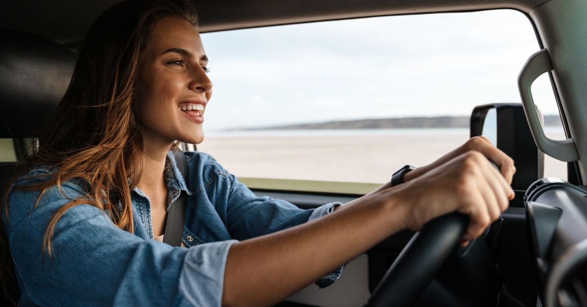 attractive young woman driving car