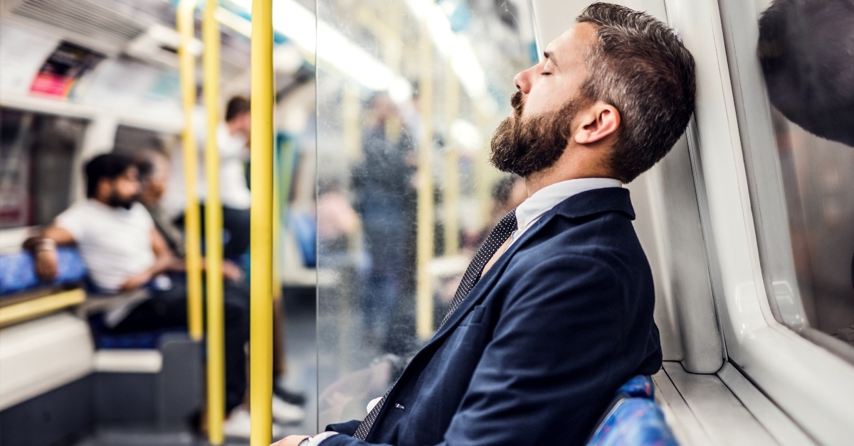 businessman sleeping inside the subway