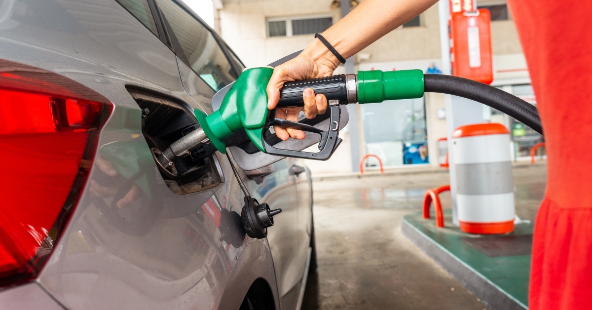 woman refueling gasoline at gas station in fuel crisis