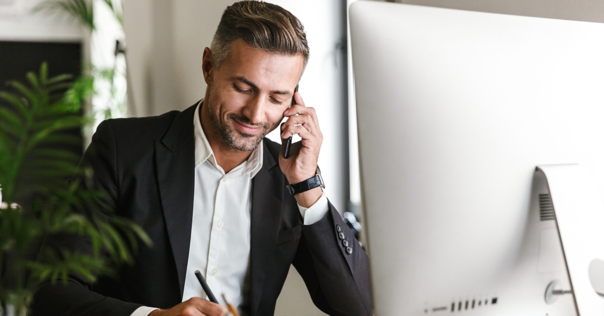 businessman talking on cellphone while working