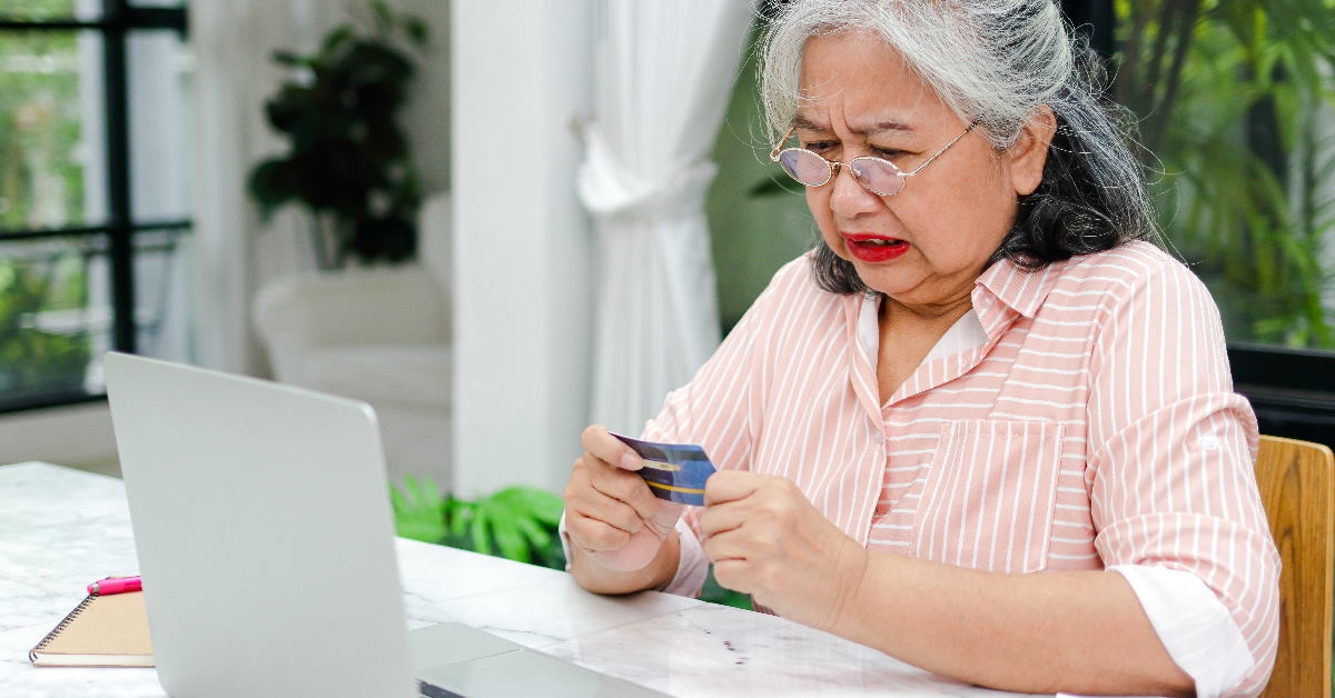 senior asian woman holding credit card