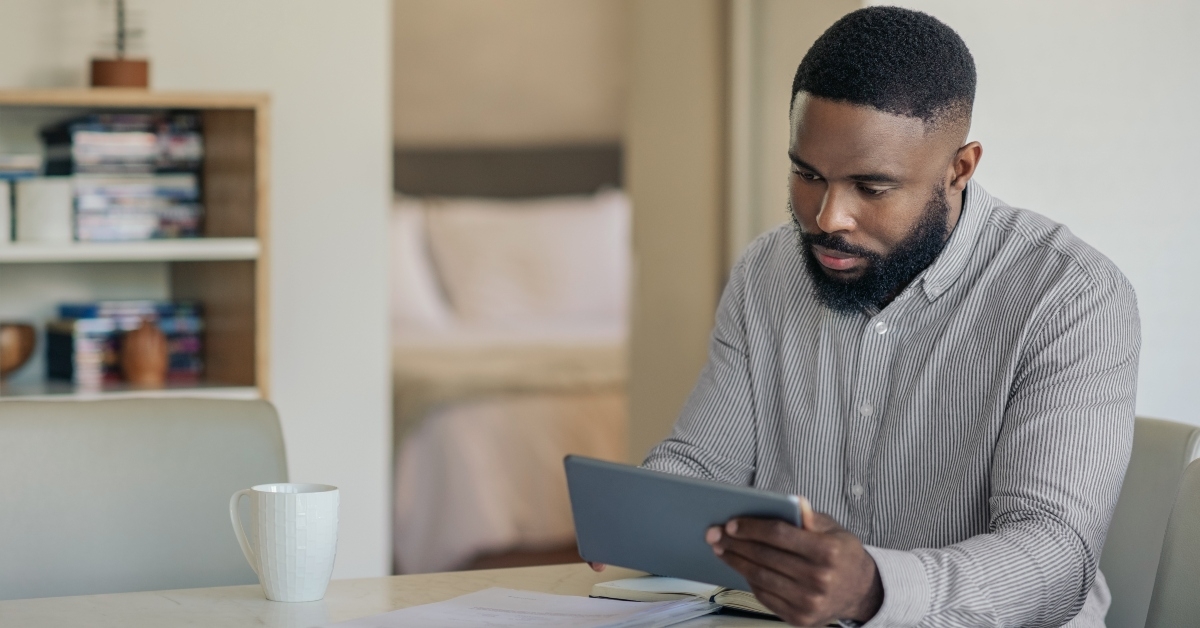 man doing his online banking with a tablet
