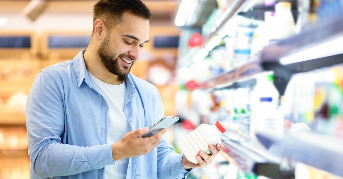 man scanning code on products using smartphone
