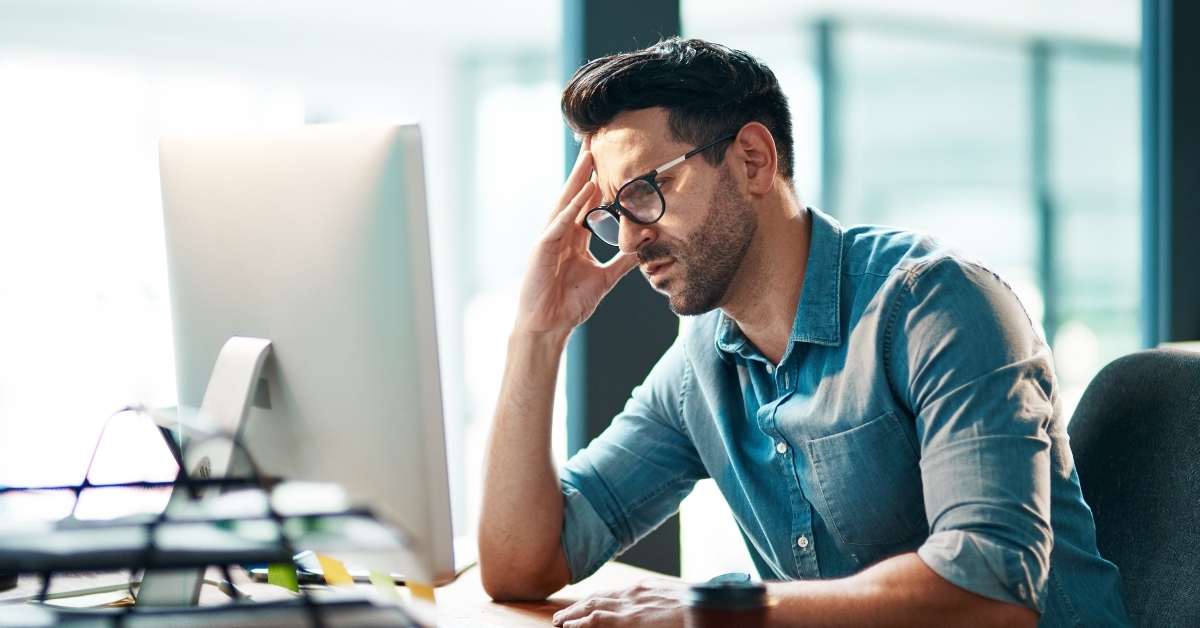 frustrated businessman working on computer in an office