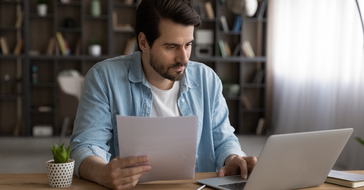 focused businessman using laptop looking at screen