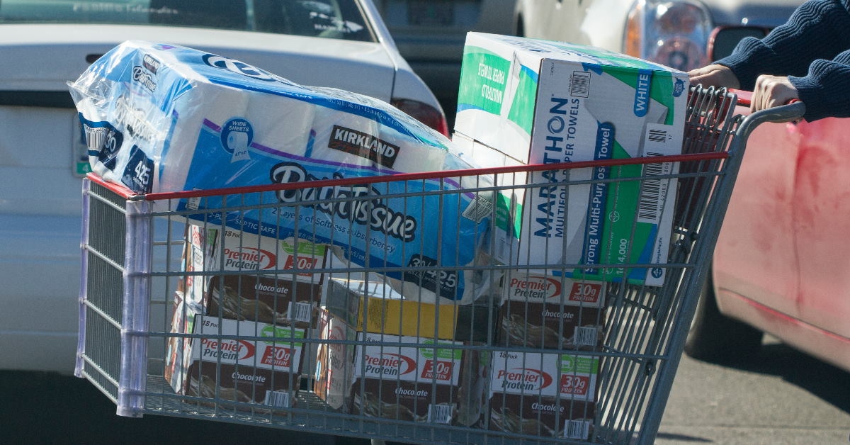 shopper outside store moving around trolley with different home items in tigard