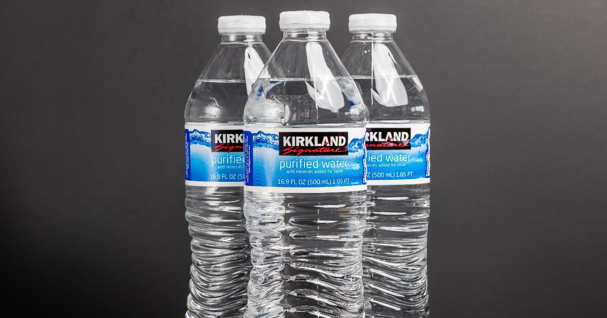 kirkland signature purified water bottles on table with black background