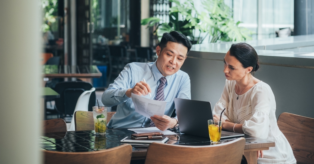 businessman explaining his idea for new project to businesswoman
