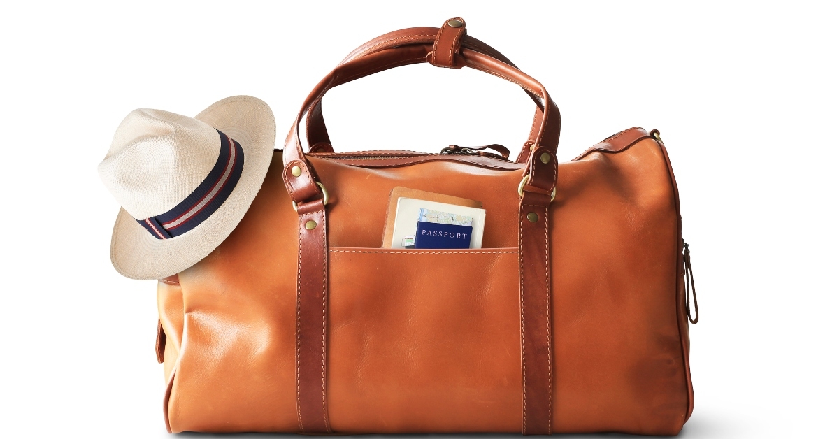 large classic brown leather travel bag with hat