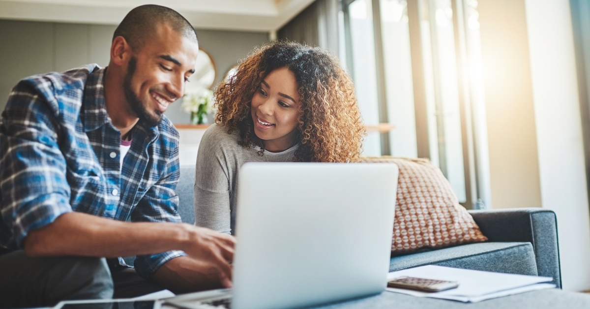 ebanking couple working on laptop looking happy