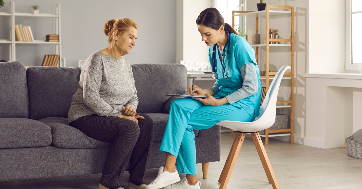 female doctor listens to a health complaint from an elderly woman