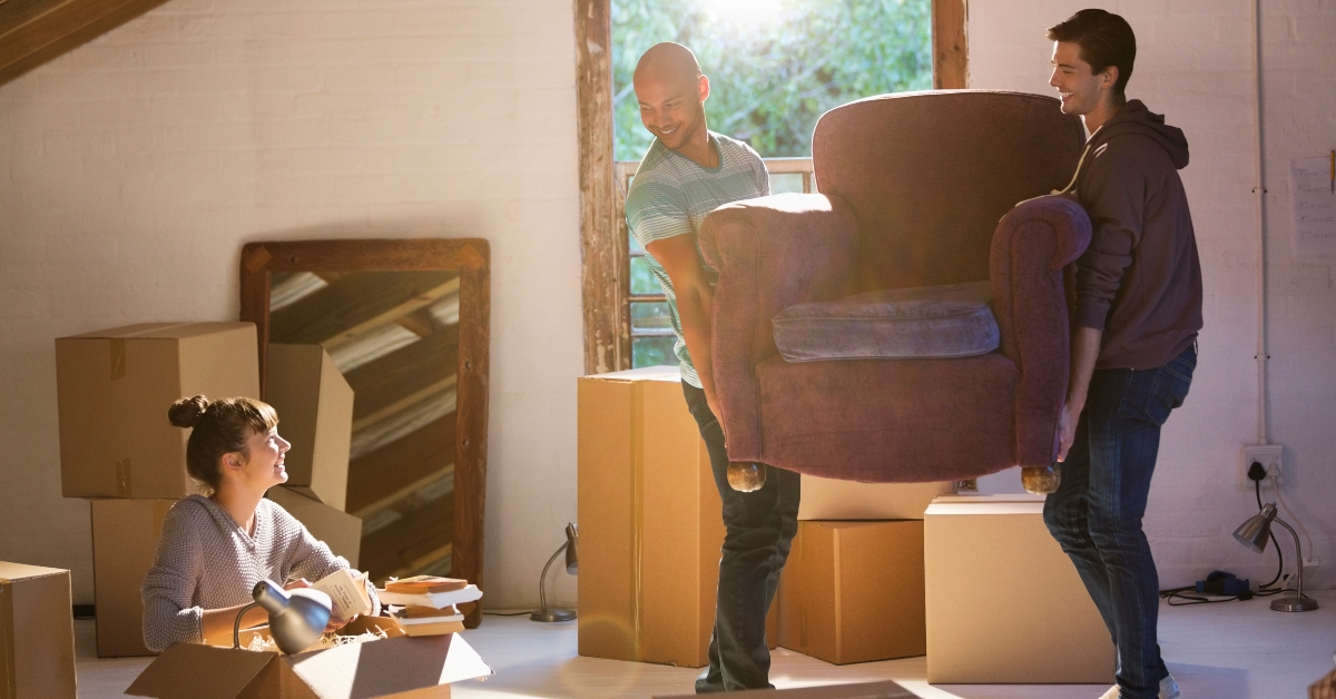 friends moving furniture in new home