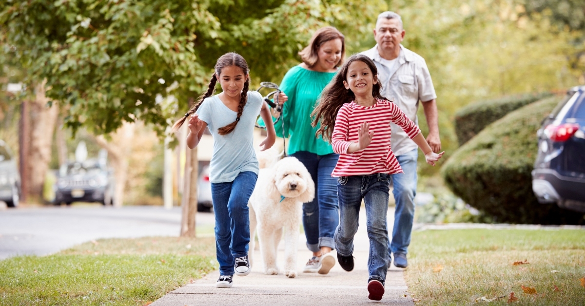 grandparents and grandchildren walking along the street
