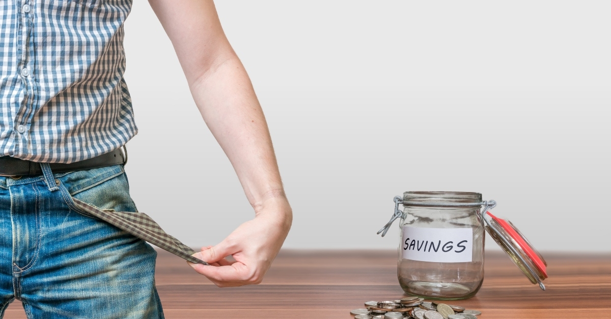 man showing pocket as no money symbol and jar with coins