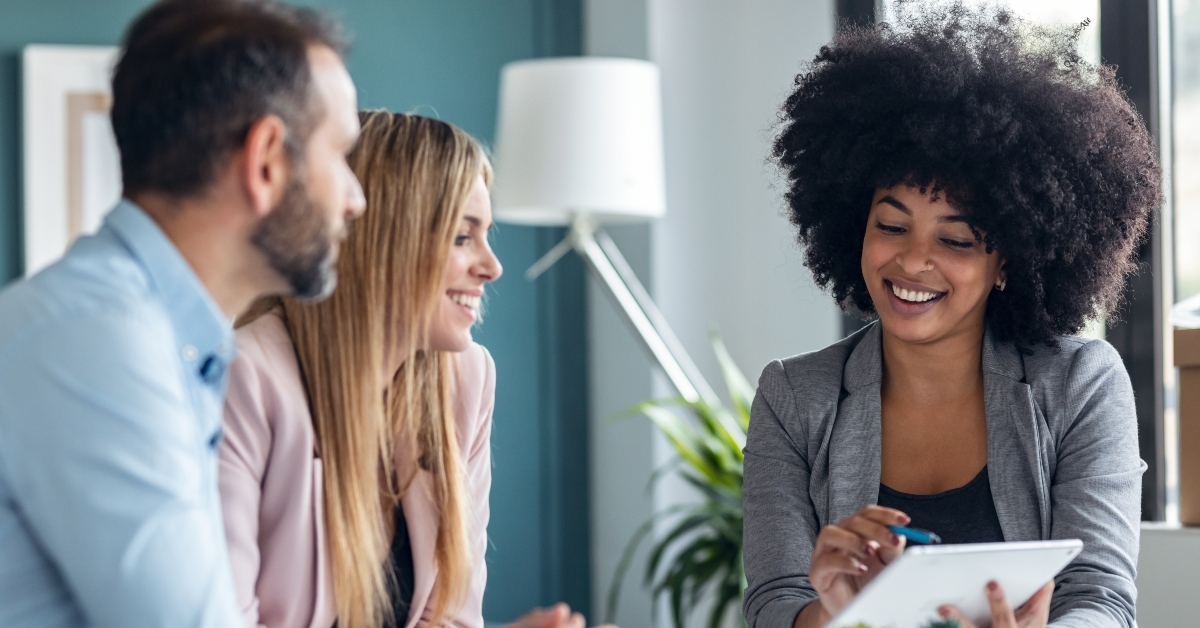 real-estate agent showing house plans on electronic tablet